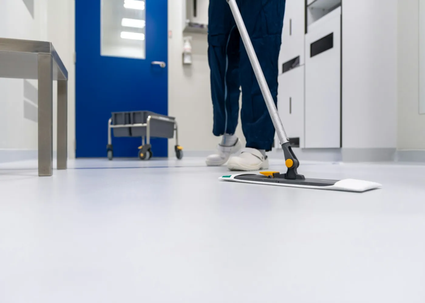A cleaner mopping a floor